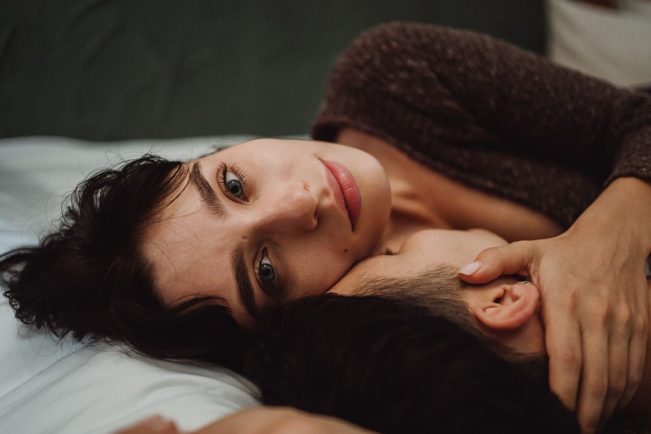 Close-up of a couple embracing, showcasing intimacy and emotional connection indoors.